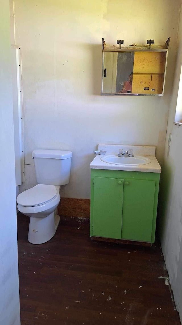 bathroom featuring vanity, toilet, and hardwood / wood-style flooring