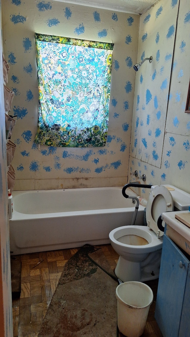 bathroom with parquet floors, vanity, and toilet