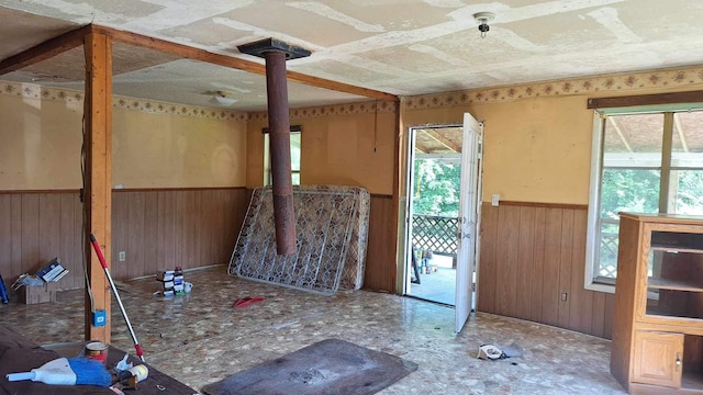 interior space featuring wooden walls and a wood stove