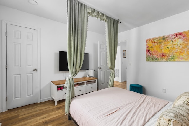 bedroom with wood-type flooring