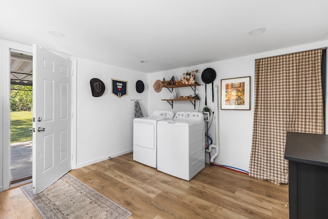 washroom with wood-type flooring and washer and clothes dryer