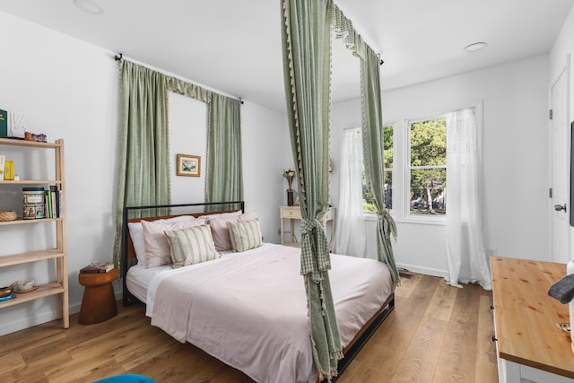 bedroom with hardwood / wood-style floors