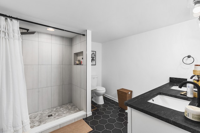 bathroom featuring a shower with shower curtain, tile patterned floors, vanity, and toilet