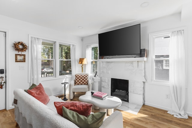 living room featuring light hardwood / wood-style floors and a fireplace