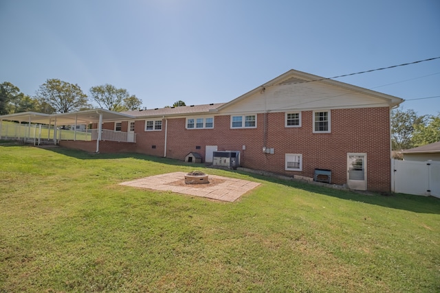 back of property featuring a lawn, central AC, a patio area, and an outdoor fire pit