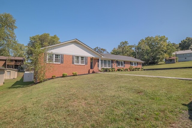 ranch-style house with a front lawn