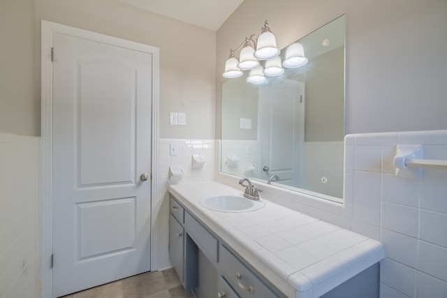 bathroom with vanity, tile walls, and tile patterned flooring