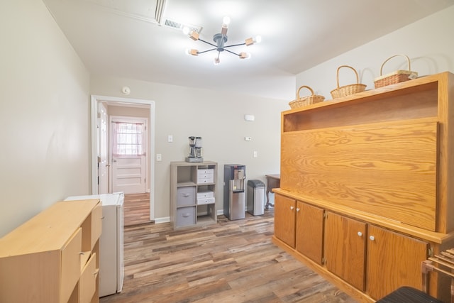 office area with a notable chandelier and light hardwood / wood-style floors