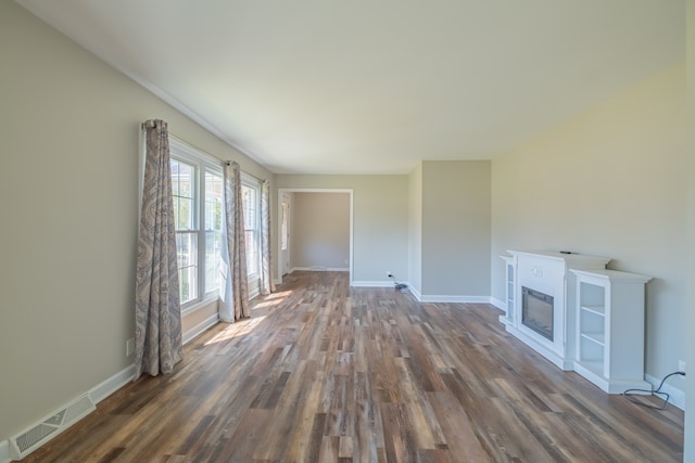 unfurnished living room featuring dark hardwood / wood-style flooring