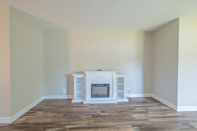 unfurnished living room with wood-type flooring