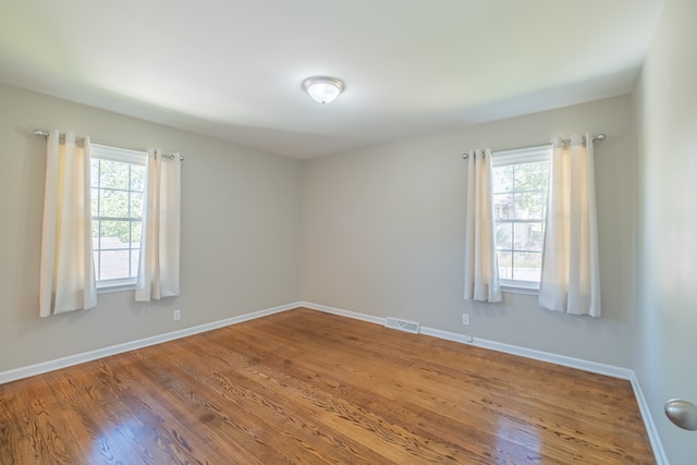 empty room with hardwood / wood-style floors