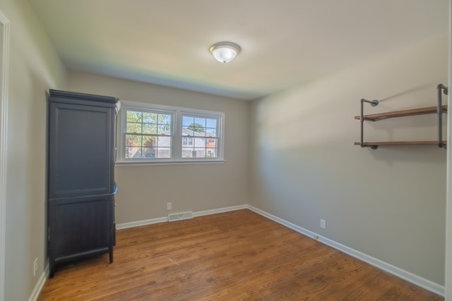 empty room with hardwood / wood-style floors