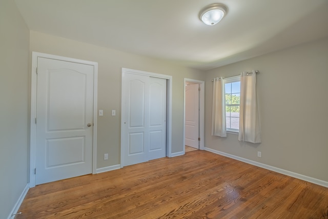 unfurnished bedroom featuring light wood-type flooring