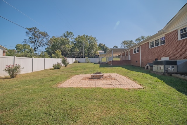 view of yard with a patio and an outdoor fire pit