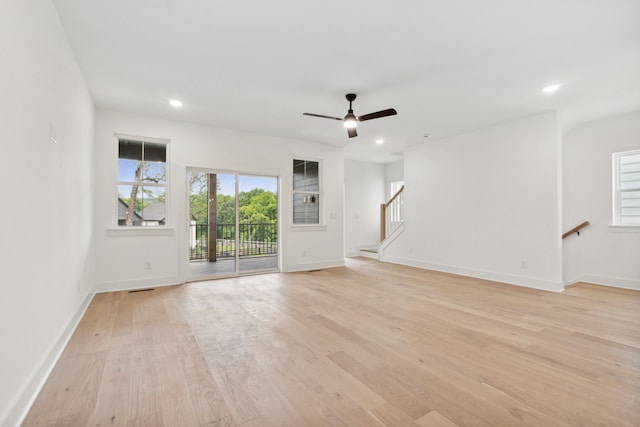 unfurnished living room with light wood-type flooring and ceiling fan