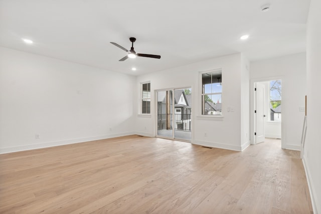 spare room with ceiling fan and light wood-type flooring