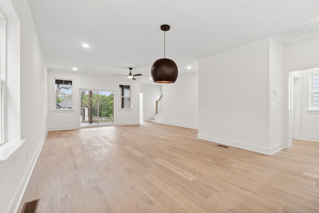 unfurnished living room featuring light wood-type flooring and ceiling fan