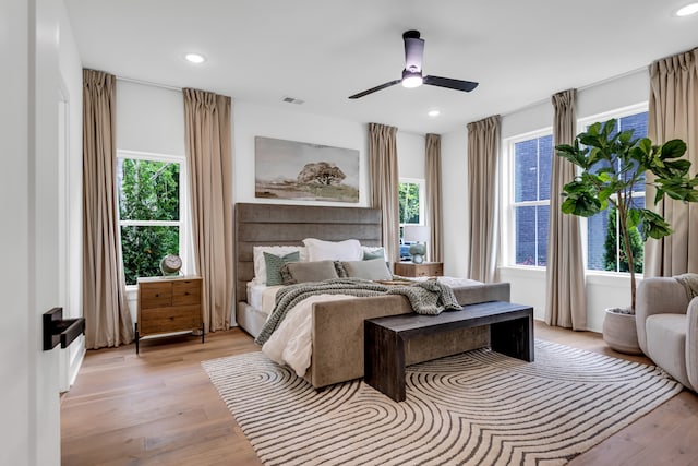 bedroom with light hardwood / wood-style flooring and ceiling fan