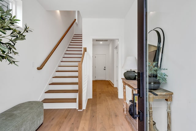 staircase with wood-type flooring