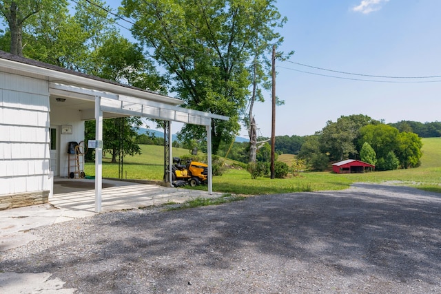 view of parking / parking lot featuring a lawn