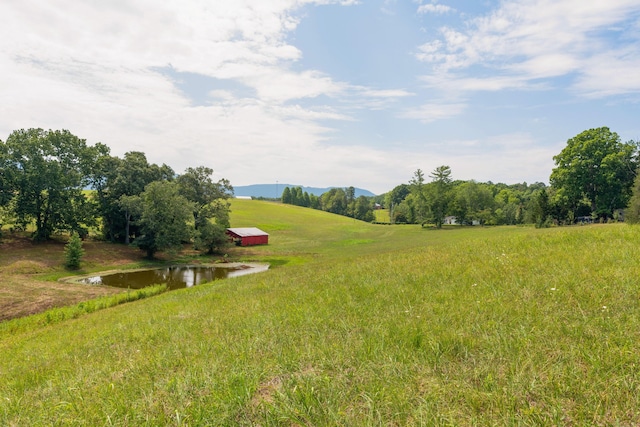 view of yard featuring a water view and a rural view