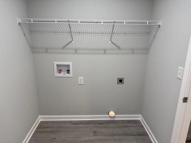 laundry room featuring electric dryer hookup, hookup for a washing machine, and dark wood-type flooring