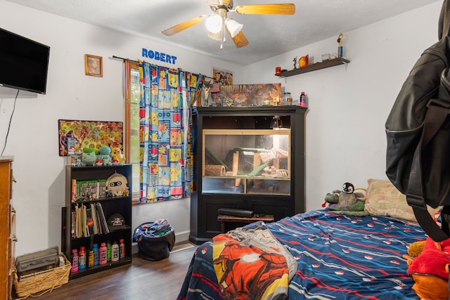 bedroom featuring ceiling fan, hardwood / wood-style flooring, and a textured ceiling