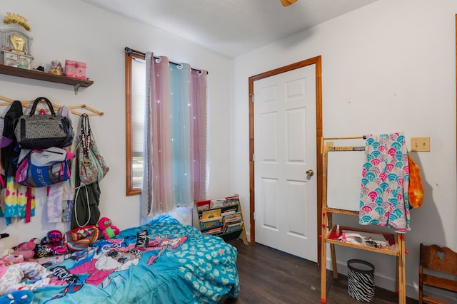 bedroom with dark hardwood / wood-style floors