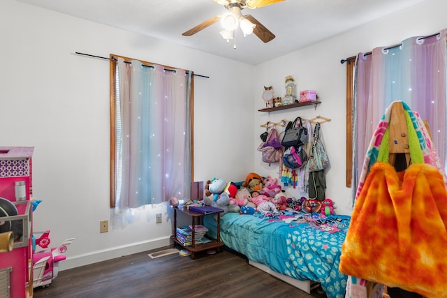 bedroom with dark hardwood / wood-style flooring and ceiling fan