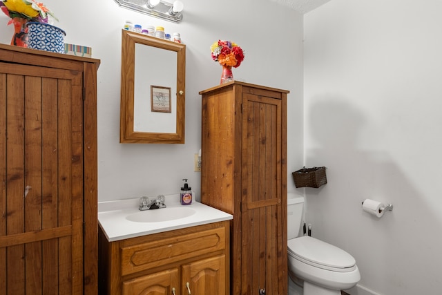 bathroom featuring vanity, toilet, and a textured ceiling