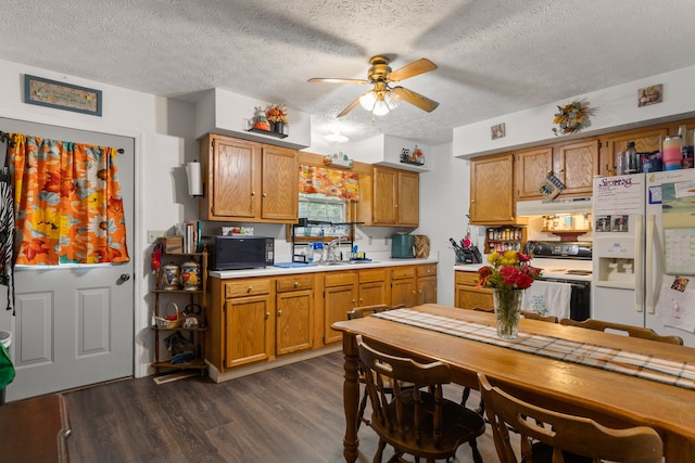 kitchen featuring ceiling fan, a textured ceiling, dark wood-type flooring, and white appliances