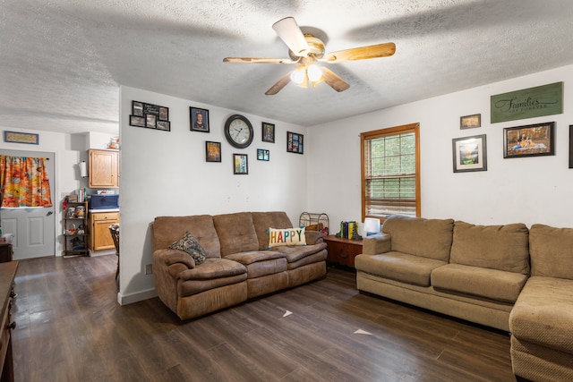 living room with ceiling fan, a textured ceiling, and dark hardwood / wood-style flooring