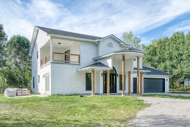 view of front of house with a balcony and a front yard