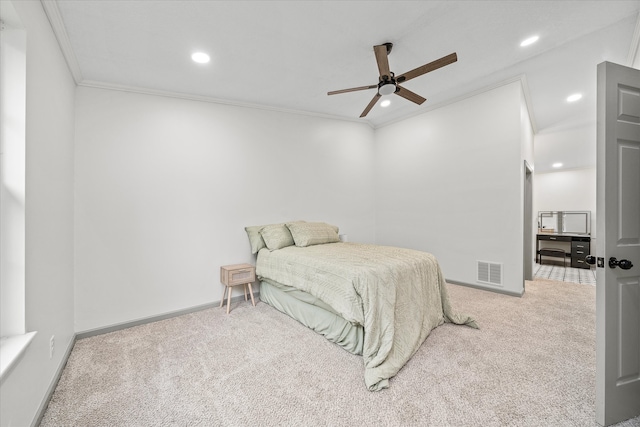 carpeted bedroom with ceiling fan and ornamental molding