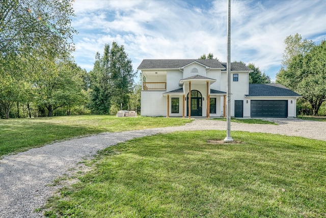 view of front of home with a front yard and a garage