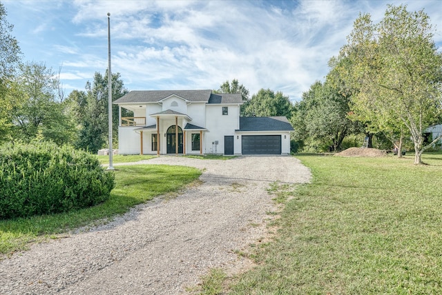 view of front of property featuring a garage and a front lawn