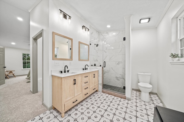 bathroom with ornamental molding, vanity, toilet, and a shower with shower door