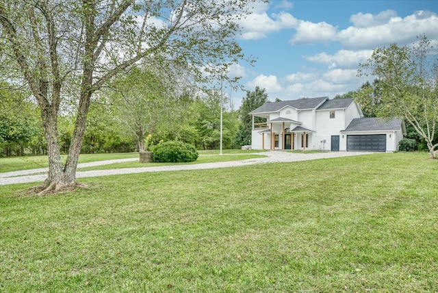 view of front of house featuring a garage and a front lawn