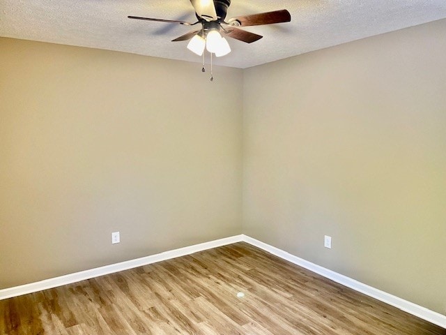 spare room featuring hardwood / wood-style floors, ceiling fan, and a textured ceiling