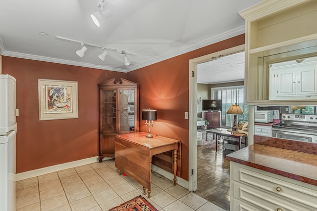 kitchen with crown molding, light tile patterned floors, white appliances, and rail lighting