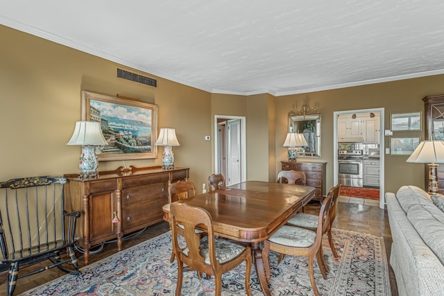 dining room featuring hardwood / wood-style flooring and crown molding