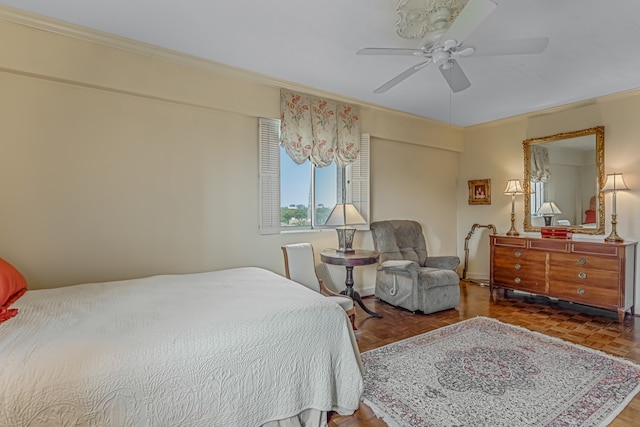 bedroom with ceiling fan, ornamental molding, and parquet floors