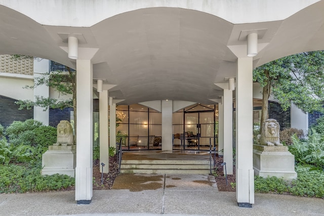 view of exterior entry featuring covered porch