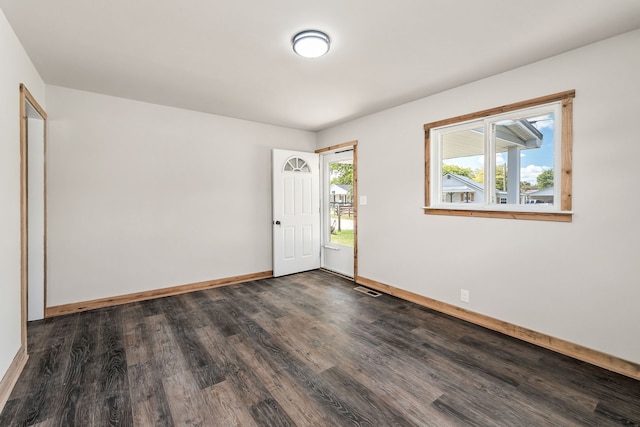 empty room featuring dark wood-type flooring