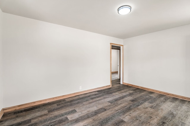 empty room with dark hardwood / wood-style floors