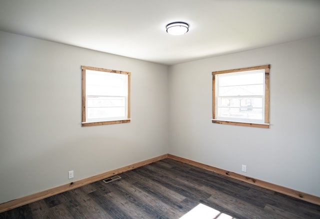 empty room with dark hardwood / wood-style floors