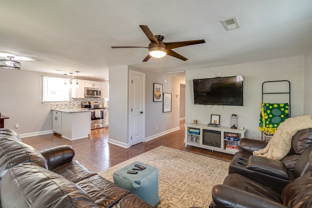 living room featuring ceiling fan and hardwood / wood-style flooring