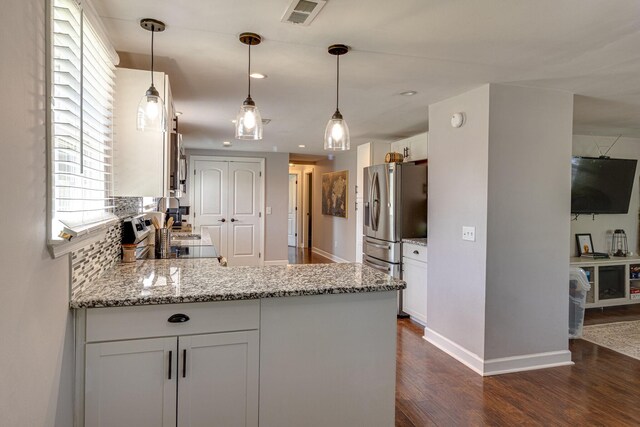 kitchen with pendant lighting, dark wood-type flooring, kitchen peninsula, and white cabinetry