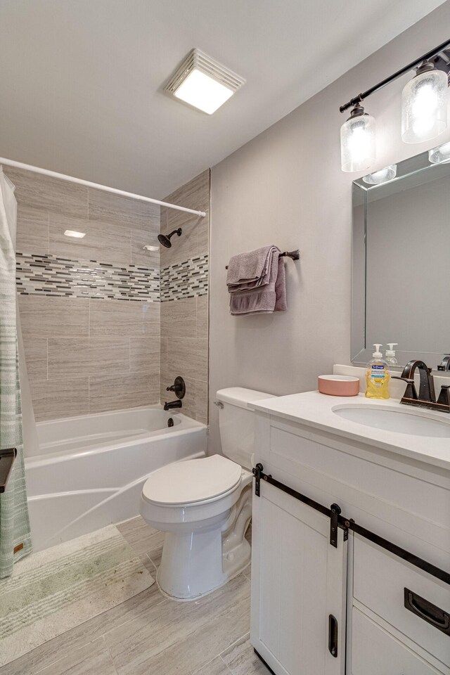 full bathroom with shower / tub combo, vanity, toilet, and hardwood / wood-style flooring