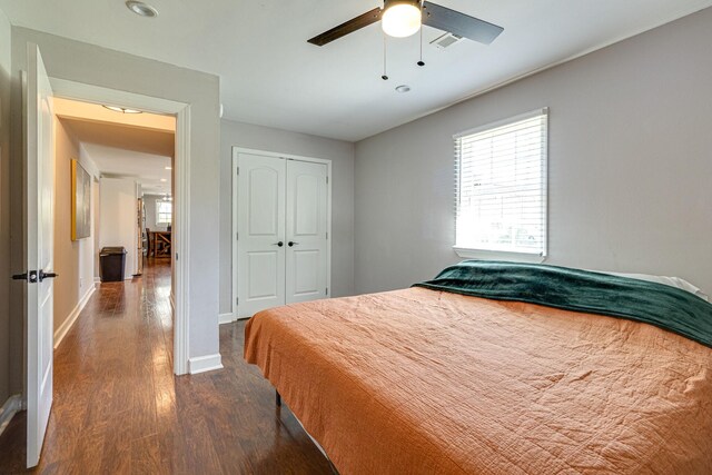 bedroom featuring ceiling fan, a closet, and dark hardwood / wood-style flooring